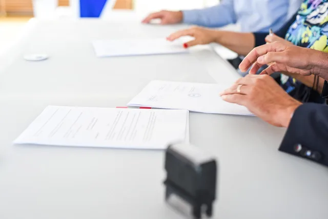 agreement, contract signing, table, hands, sign, contract, paper, paper work, meeting, business, closeup, agreement, contract, contract, contract, contract, contract. What a creator contracts disclosure policy means for England campaigns